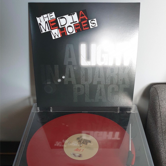 the-media-whores-a-light-in-a-dark-place-lp-player.jpg